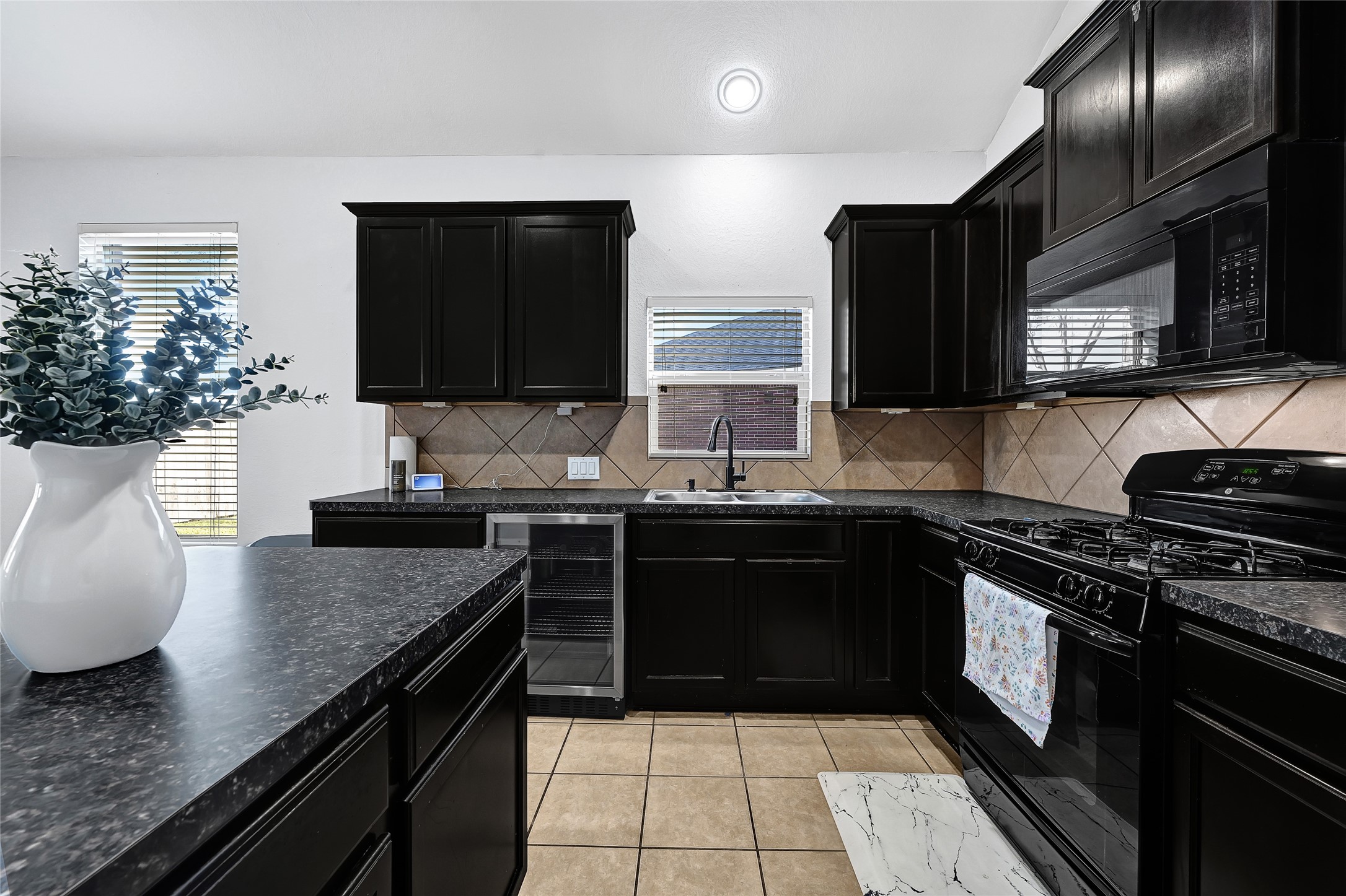 11 Supiro Court Manvel, TX 77578 - Photo 11 of 21 a kitchen with stainless steel appliances granite countertop a sink stove and microwave