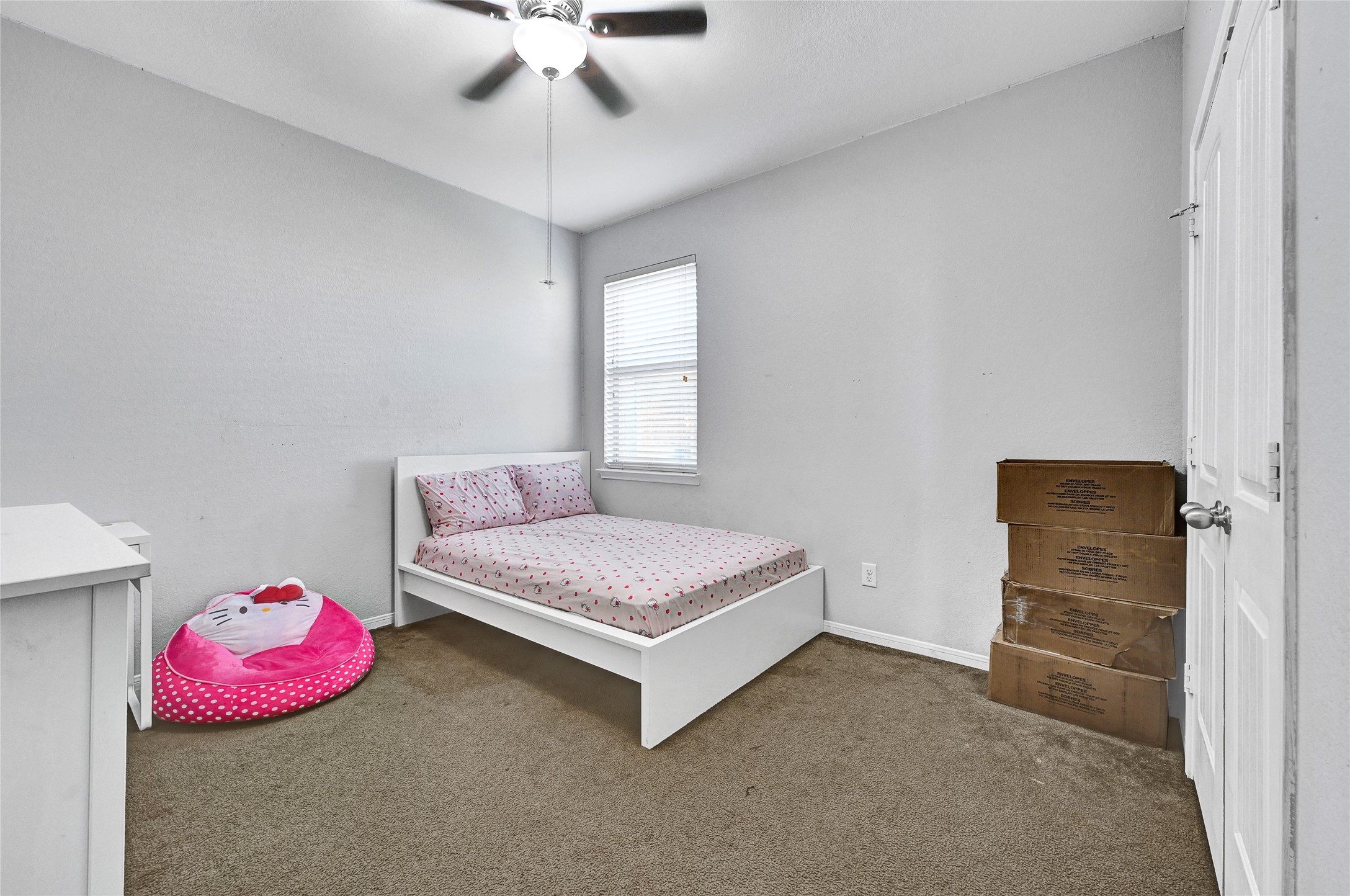 11 Supiro Court Manvel, TX 77578 - Photo 18 of 21 a spacious bedroom with a bed and a chandelier