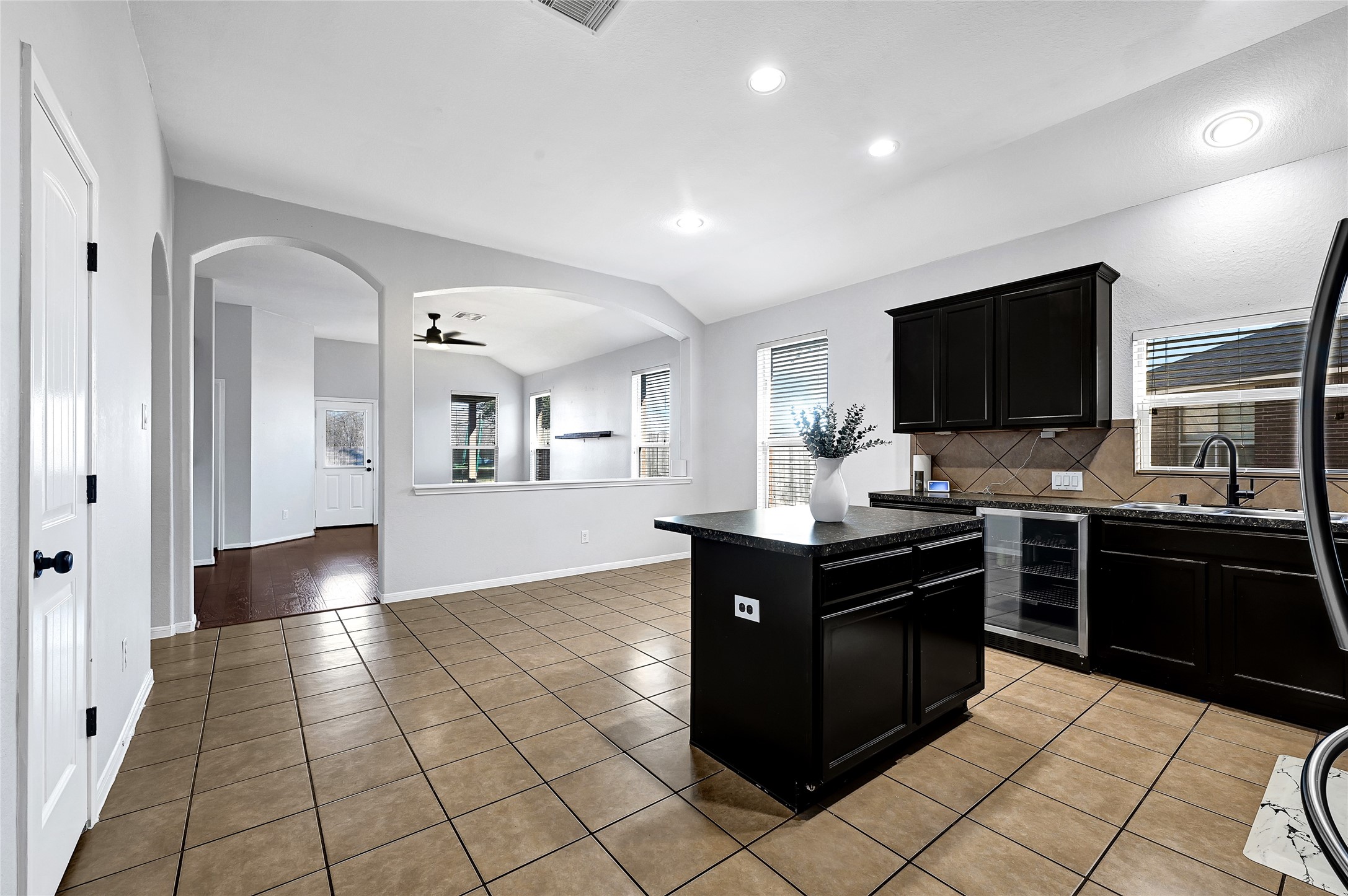 11 Supiro Court Manvel, TX 77578 - Photo 3 of 21 a kitchen with granite countertop a refrigerator and a stove top oven