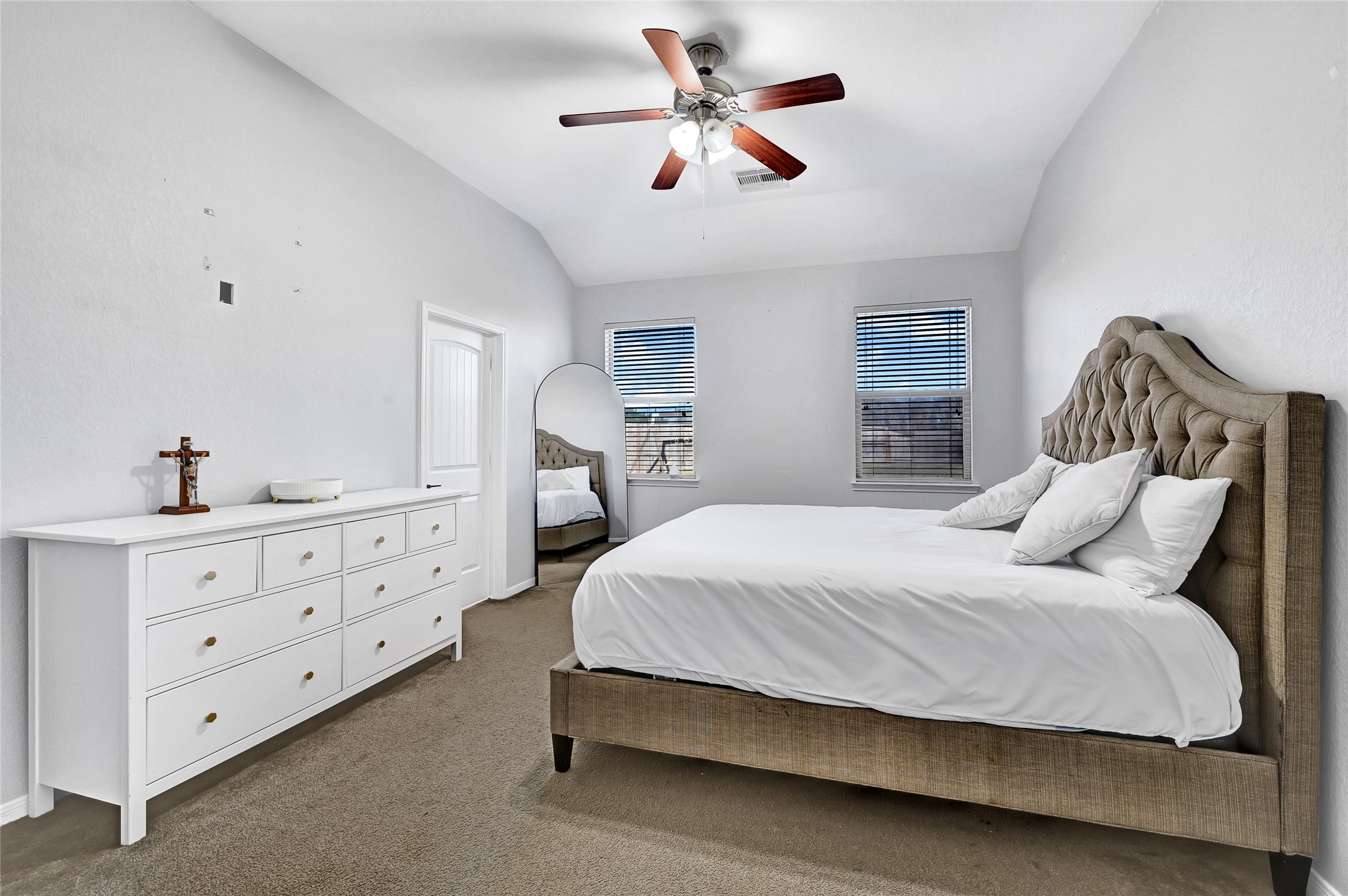 11 Supiro Court Manvel, TX 77578 - Photo 6 of 21 a bedroom with a bed chandelier and a dresser