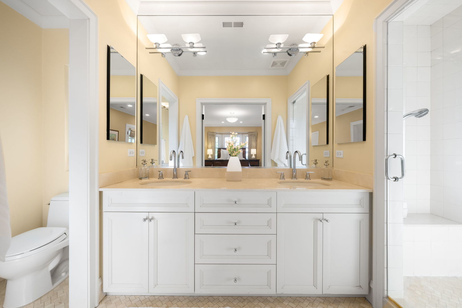 693 Sheridan Road Wilmette, IL 60091 - Photo 19 of 45 a bathroom with a granite countertop sink a toilet a mirror and a shower