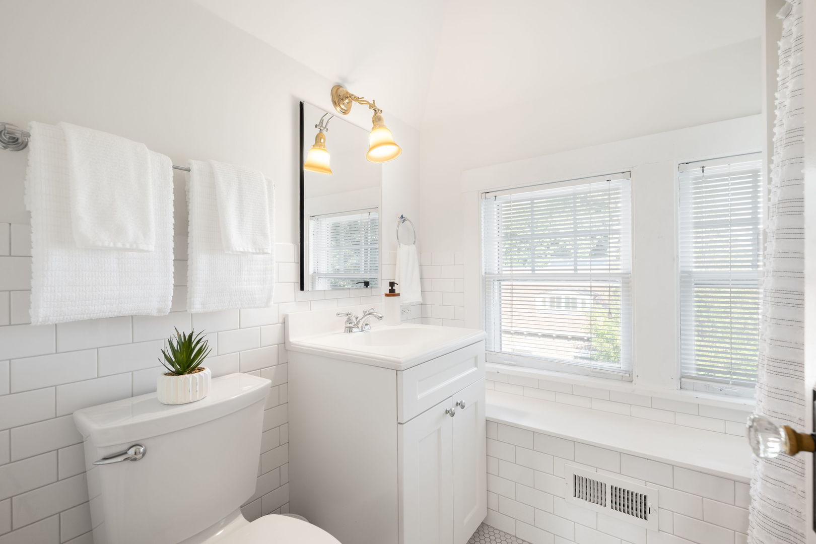 693 Sheridan Road Wilmette, IL 60091 - Photo 29 of 45 a bathroom with a sink a toilet and a mirror