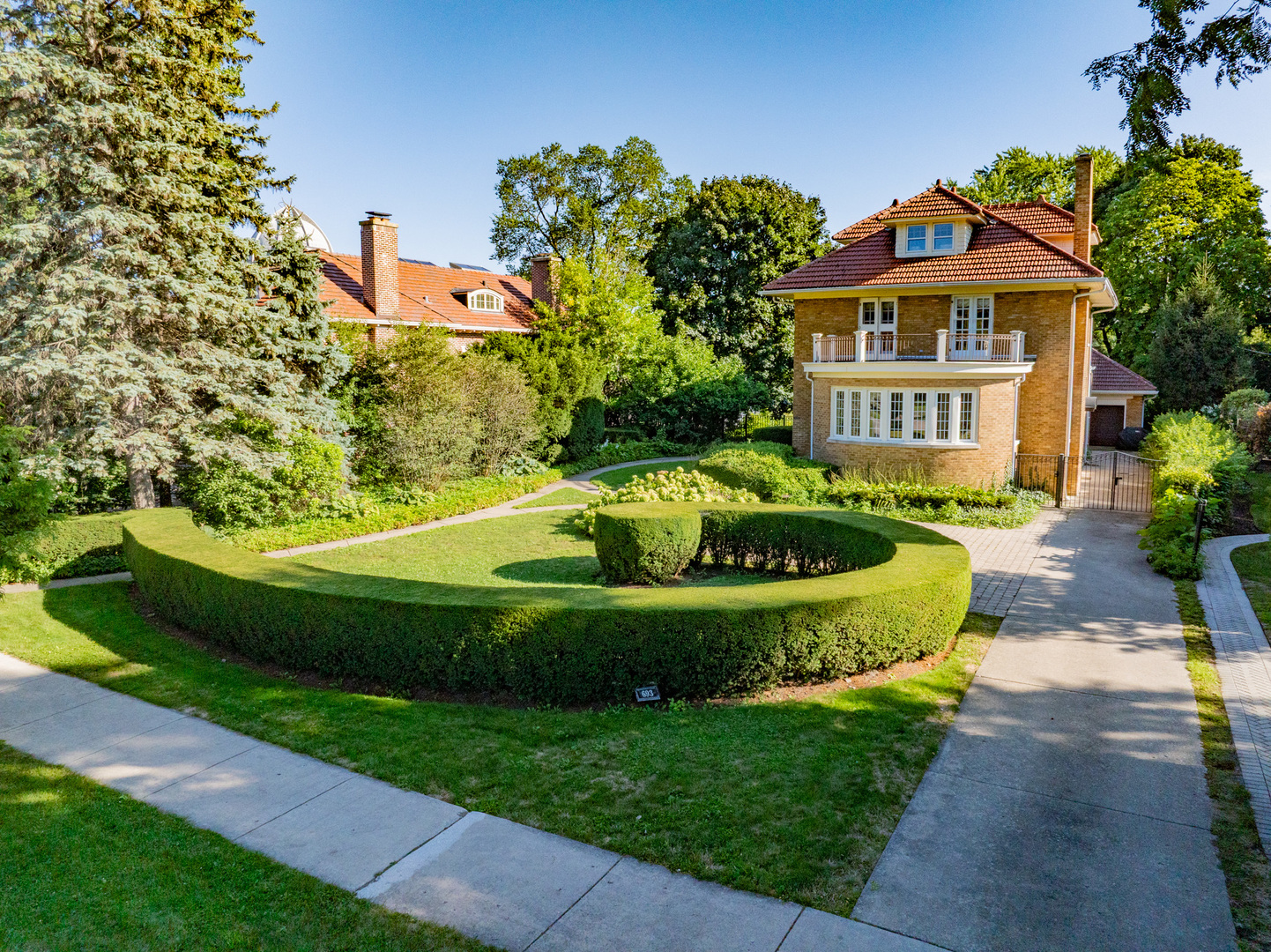 693 Sheridan Road Wilmette, IL 60091 - Photo 3 of 45 a view of a swimming pool with a garden and plants