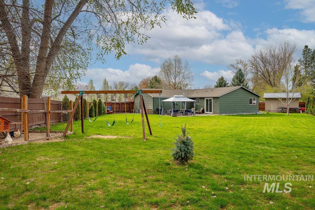405 North 2nd Street Eagle, ID 83616 - Photo 25 of 39 Fenced yard featuring a patio area, a gazebo, and a playground