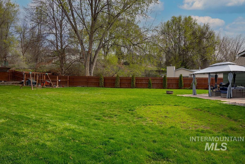 405 North 2nd Street Eagle, ID 83616 - Photo 26 of 39 Fenced backyard featuring a patio area, a gazebo, and a playground