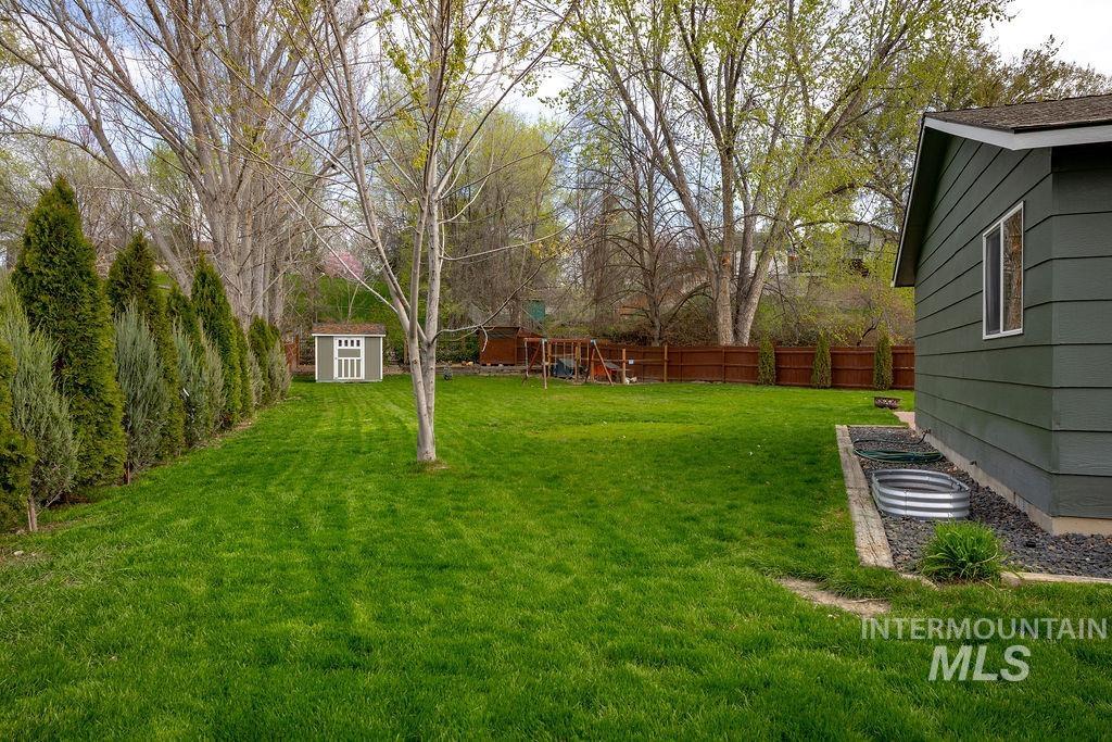 405 North 2nd Street Eagle, ID 83616 - Photo 29 of 39 Fenced backyard with a storage unit