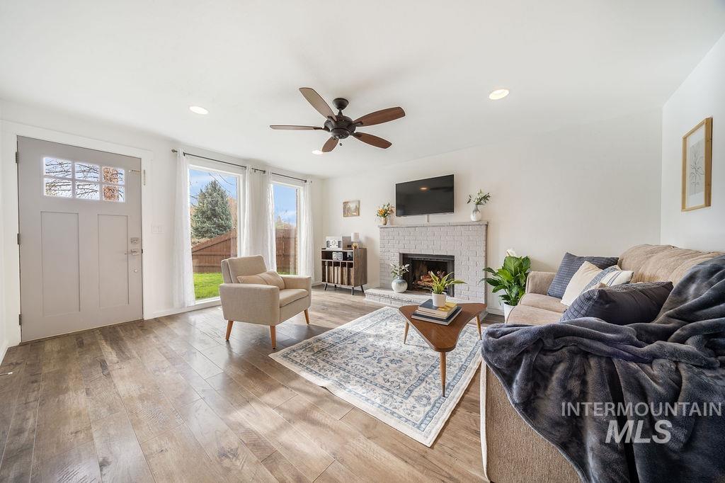 405 North 2nd Street Eagle, ID 83616 - Photo 3 of 39 Living room with a ceiling fan, a fireplace, light wood-style floors, and recessed lighting