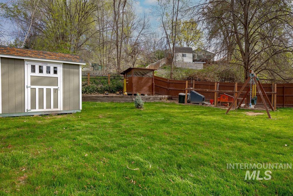 405 North 2nd Street Eagle, ID 83616 - Photo 31 of 39 Fenced backyard with a storage unit