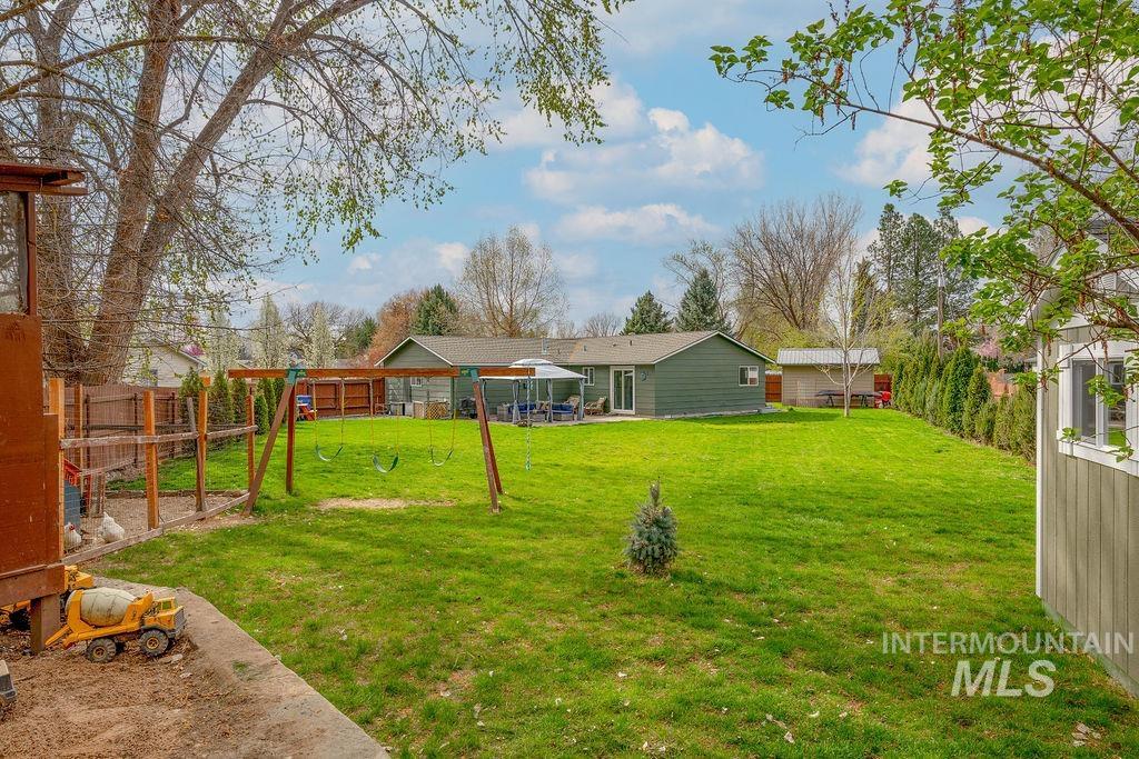 405 North 2nd Street Eagle, ID 83616 - Photo 33 of 39 Fenced yard with a playground and a patio area