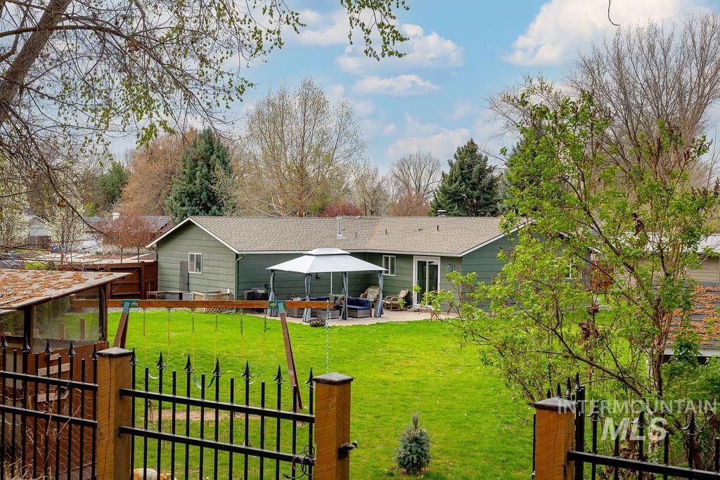 405 North 2nd Street Eagle, ID 83616 - Photo 36 of 39 Back of property featuring a patio and roof with shingles