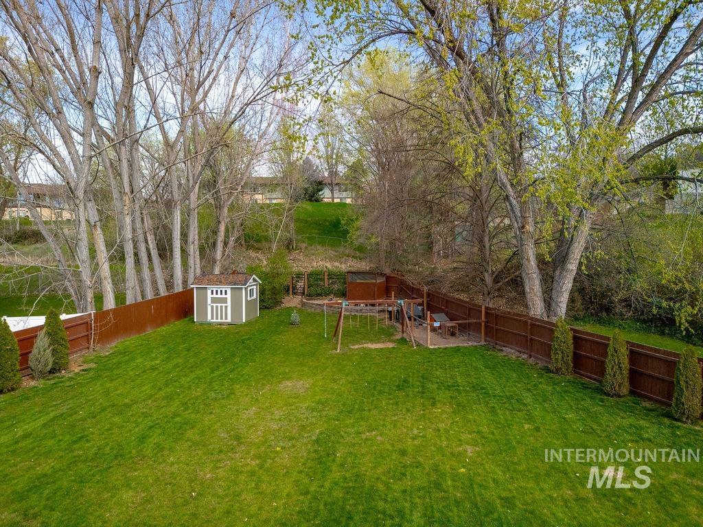 405 North 2nd Street Eagle, ID 83616 - Photo 38 of 39 Fenced backyard featuring a shed and a playground