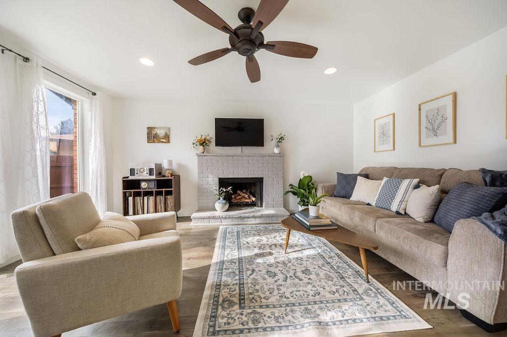 405 North 2nd Street Eagle, ID 83616 - Photo 4 of 39 Living area featuring a brick fireplace, a ceiling fan, and recessed lighting