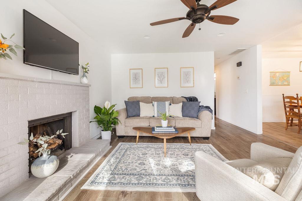 405 North 2nd Street Eagle, ID 83616 - Photo 5 of 39 Living room with a ceiling fan, wood finished floors, and a fireplace