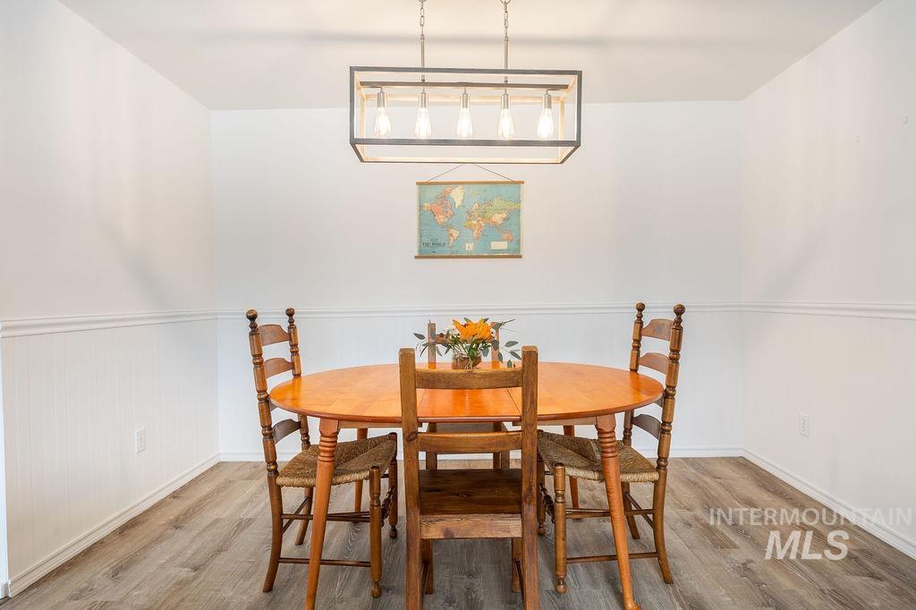 405 North 2nd Street Eagle, ID 83616 - Photo 10 of 39 Dining space with light wood-style floors and a wainscoted wall