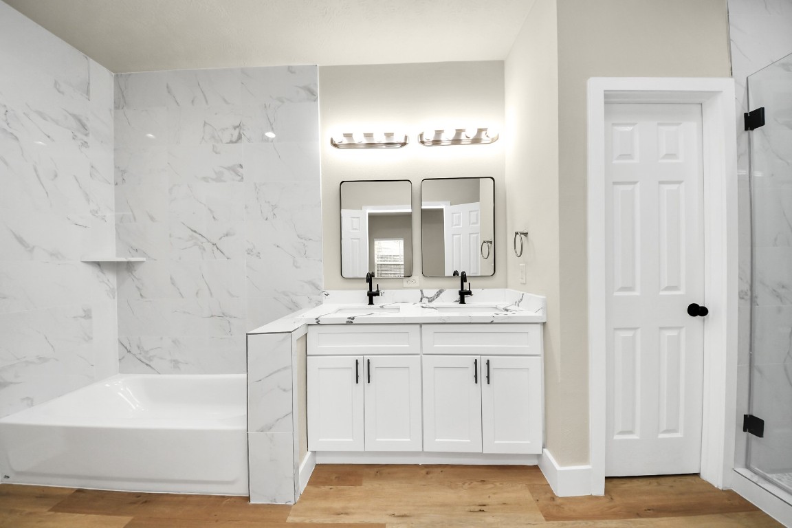 5211 Amy Street, Unit B Houston, TX 77028 - Photo 11 of 17 a bathroom with a sink a mirror and a bathtub