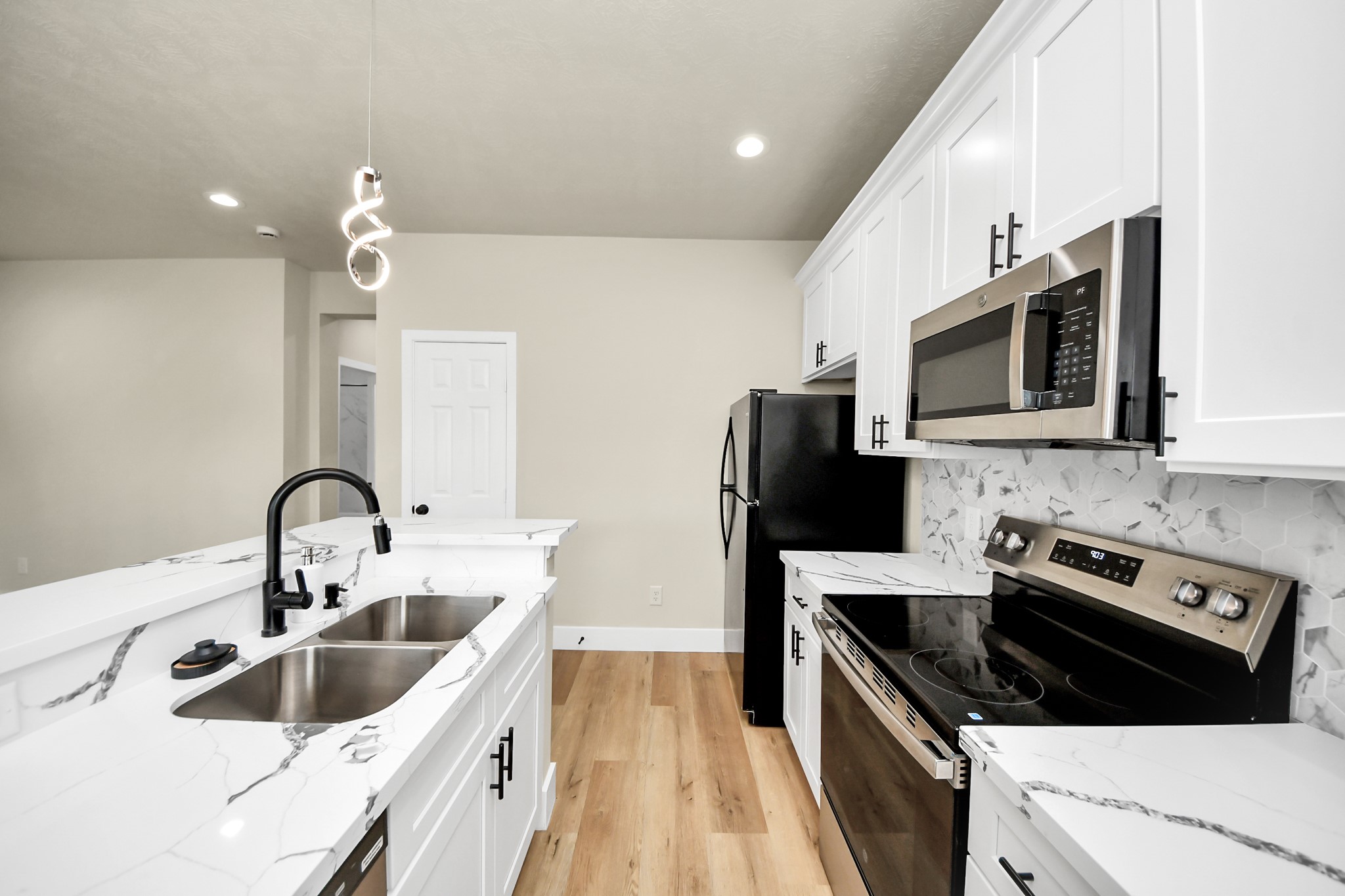 5211 Amy Street, Unit B Houston, TX 77028 - Photo 6 of 17 a kitchen with stainless steel appliances a sink a stove a microwave and wooden cabinets