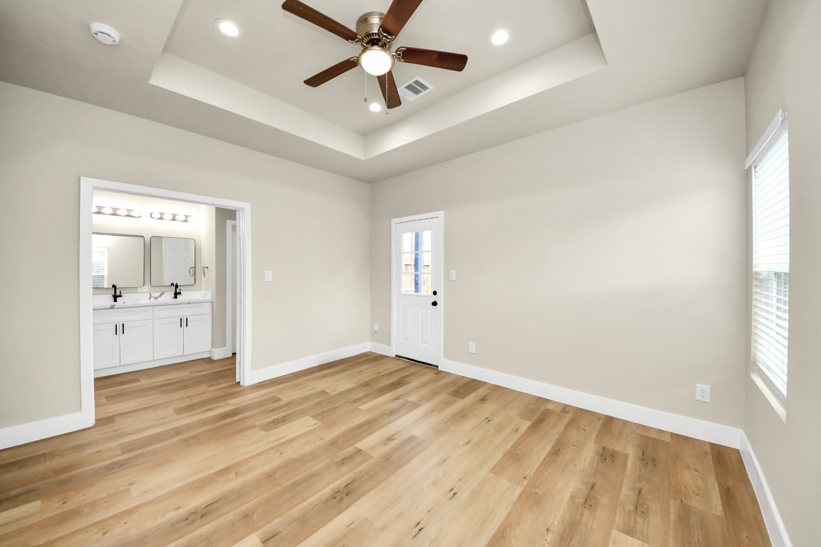 5211 Amy Street, Unit B Houston, TX 77028 - Photo 9 of 17 wooden floor in an empty room with a window