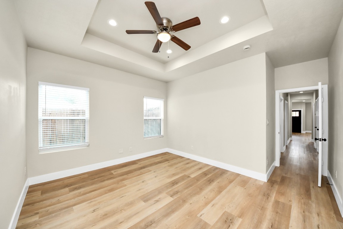 5211 Amy Street, Unit B Houston, TX 77028 - Photo 10 of 17 a view of empty room with wooden floor and fan