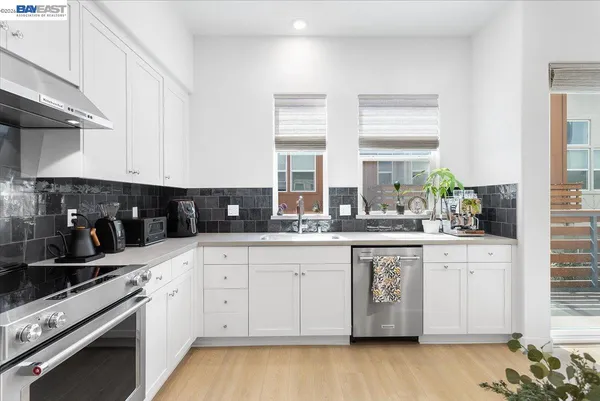 a kitchen with stainless steel appliances granite countertop a sink and cabinets