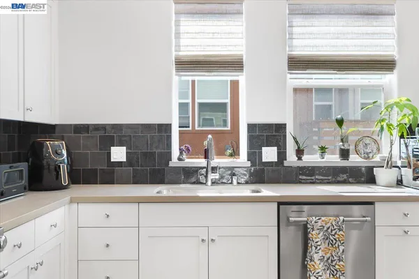 a kitchen with granite countertop a sink and cabinets