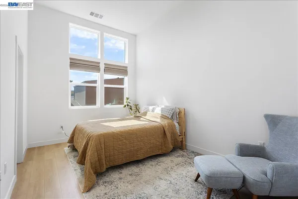 a bedroom with a bed and a couch