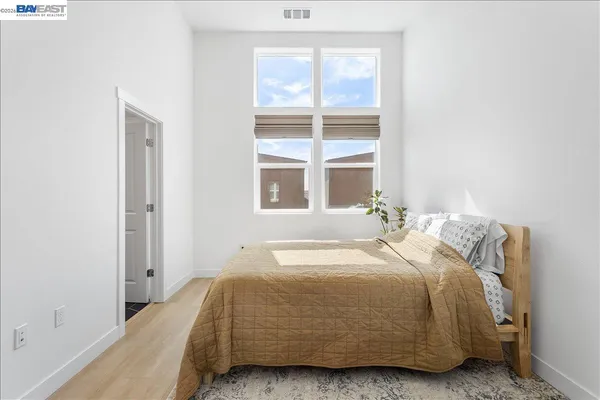 a bedroom with a bed and a window