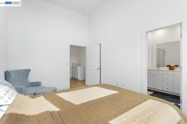 a bedroom with a bed and view of living room