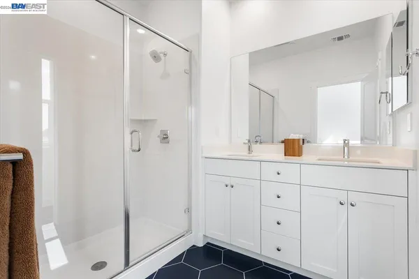a bathroom with a shower sink and mirror
