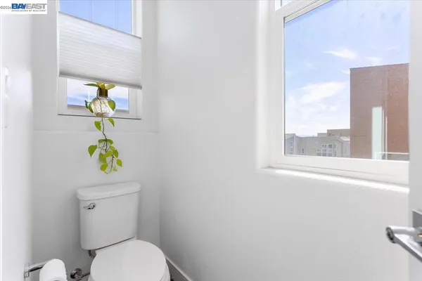 a white toilet sitting next to a window