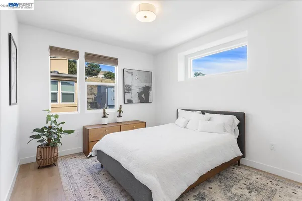a bedroom with a bed and a potted plant