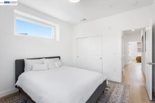 a bedroom with a bed and a mirror