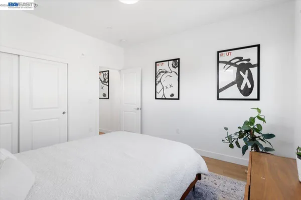 a bedroom with a bed and a potted plant