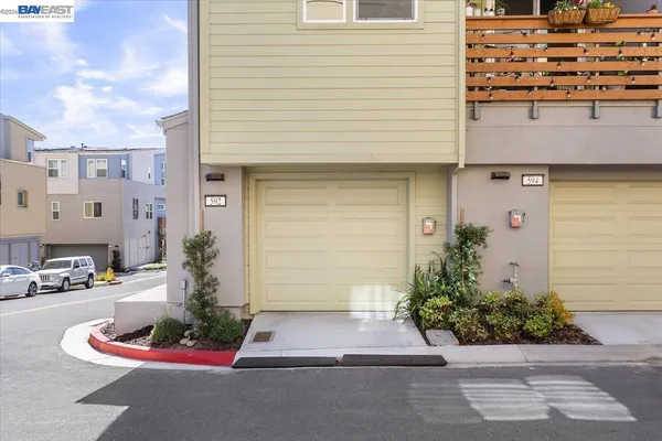 a white building with potted plants in front of it