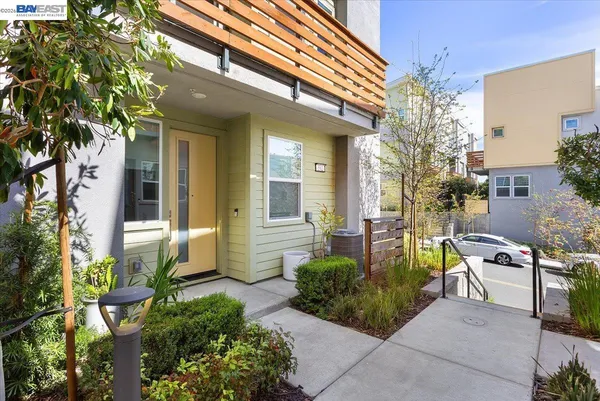 a view of a chair and tables in the patio with potted plants