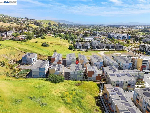 an aerial view of a building with swimming pool and ocean view