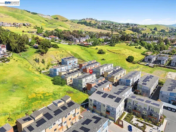 an aerial view of residential houses with outdoor space