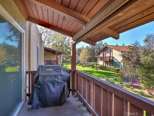 a view of a porch with furniture and garden