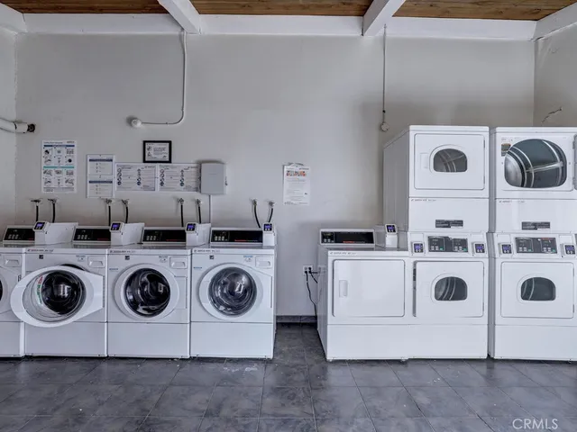 a utility room with two washing machine