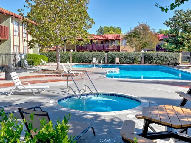 a view of a patio with table and chairs potted plants