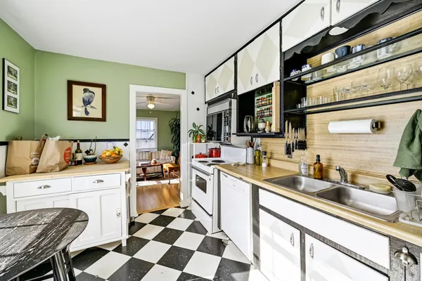 a kitchen with a sink stove and cabinets