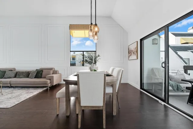 a view of a dining room with furniture and a potted plant
