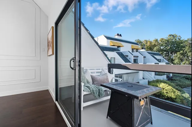 a balcony view with a sink and wooden floor