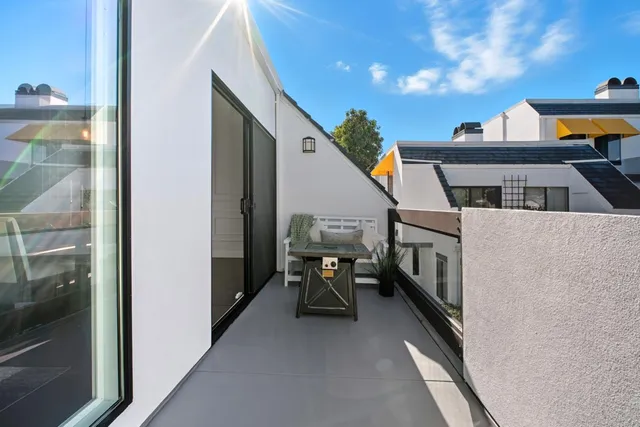 a view of a balcony with furniture and a stove