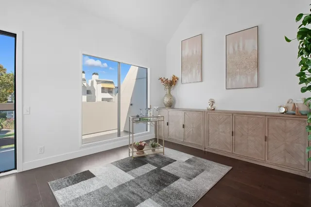 a room with wooden floor and potted plant