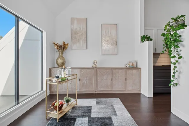 a living room with furniture and flowers