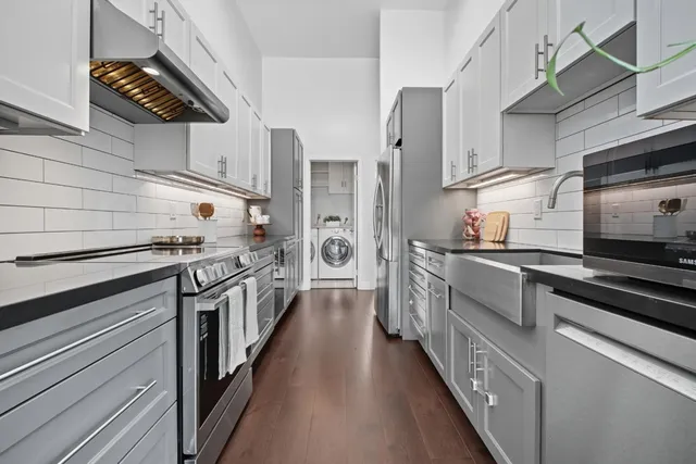 a kitchen with stainless steel appliances a stove microwave and refrigerator