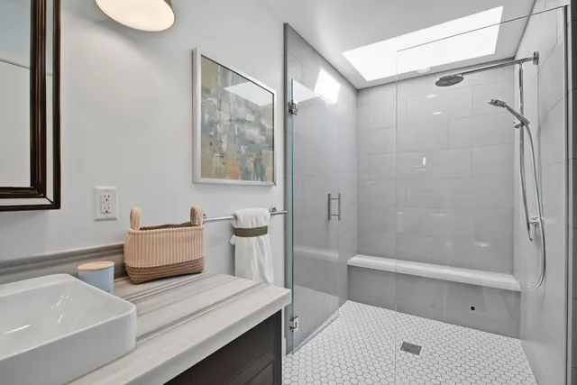 a bedroom with a bed and a flat tv screen on dresser