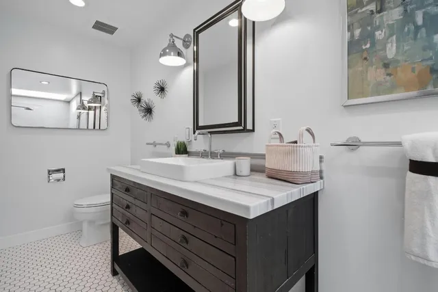a bedroom with a bed and a potted plant