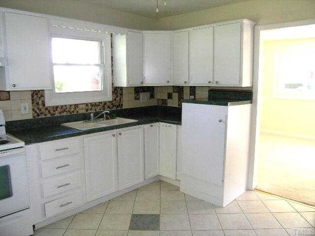 1916 Hadley Road Raleigh, NC 27610 - Photo 5 of 11 a kitchen with a sink and cabinets