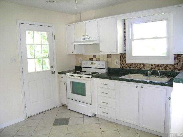 1916 Hadley Road Raleigh, NC 27610 - Photo 6 of 11 a kitchen with granite countertop white cabinets and white appliances